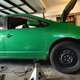 Working on the car, with the new wheels up front and the original Prius wheels on the back.